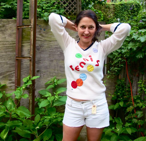 white tennis sweater that says "tennis" with balls